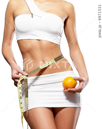 Beauty female body with measuring tape and orange 6971331