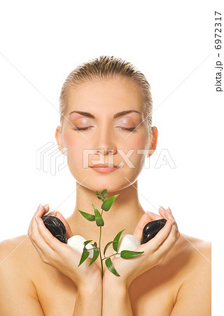 Beautiful blond girl holding young plant growing up through ston Beautiful blond girl holding young plant growing up through ston 6972317