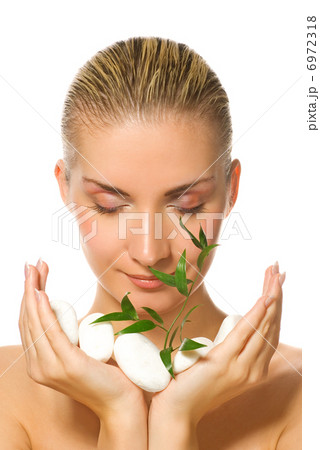Beautiful blond girl holding young plant growing up through ston Beautiful blond girl holding young plant growing up through ston 6972318