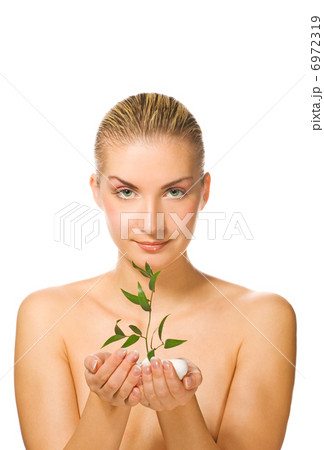 Beautiful blond girl holding young plant growing up through ston Beautiful blond girl holding young plant growing up through ston 6972319