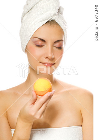 Beautiful young woman with aroma bath ball isolated on white bac 6972340