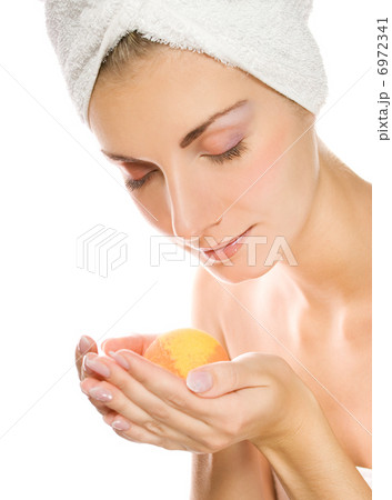 Beautiful young woman with aroma bath ball isolated on white bac 6972341