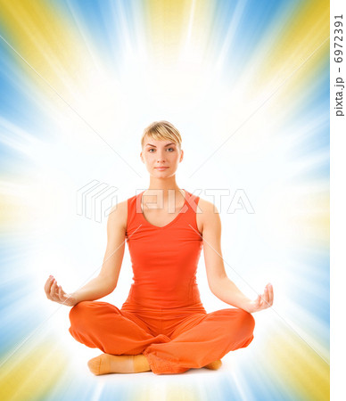 Beautiful young woman doing yoga exercise isolated on abstract b Beautiful young woman doing yoga exercise isolated on abstract b 6972391