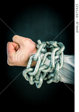 Hands wrapped in chains 6975425