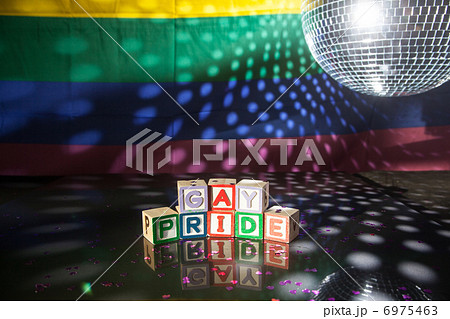 Block spelling gay pride under light of disco ball 6975463