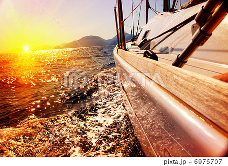 Yacht Sailing against sunset. Sailboat. Yachting. Sailing 6976707