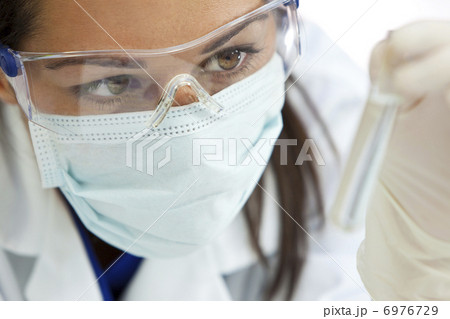 Female Scientist With Test Tube of Clear Liquid In Laboratory Female Scientist With Test Tube of Clear Liquid In Laboratory 6976729