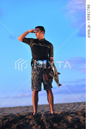 Portrait of a young kitsurf man at beach on sunset Portrait of a young kitsurf man at beach on sunset 6981786