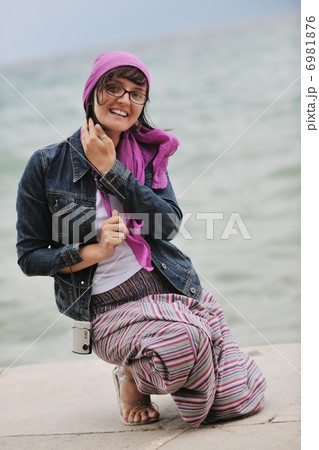 beautiful young woman on beach with scarf 6981876