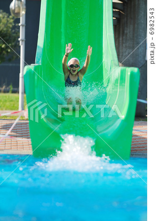 girl have fun on water slide at outdoor swimming pool 6982543