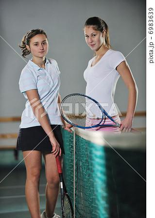 young girls playing tennis game indoor 6983639