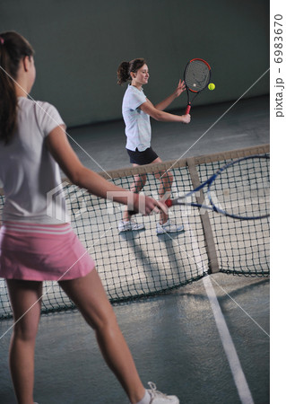 young girls playing tennis game indoor young girls playing tennis game indoor 6983670