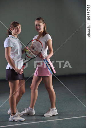 young girls playing tennis game indoor young girls playing tennis game indoor 6983745