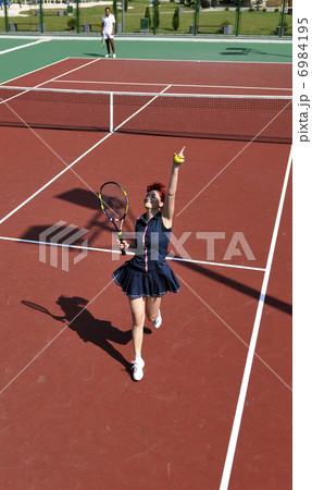 young woman play tennis game outdoor 6984195