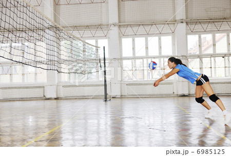 girls playing volleyball indoor game 6985125