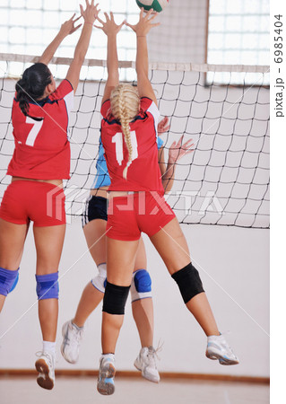 girls playing volleyball indoor game 6985404