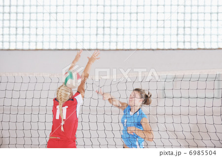 girls playing volleyball indoor game girls playing volleyball indoor game 6985504