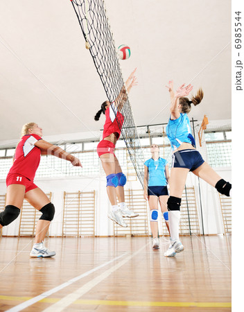 girls playing volleyball indoor game 6985544
