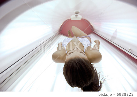 Beautiful young woman tanning in solarium Beautiful young woman tanning in solarium 6988225