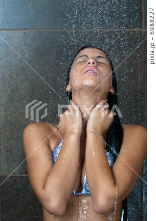 sexy young woman enjoing bath under water shower 6988227
