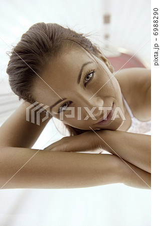 Beautiful young woman tanning in solarium 6988290
