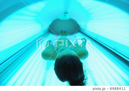 Beautiful young woman tanning in solarium Beautiful young woman tanning in solarium 6988411