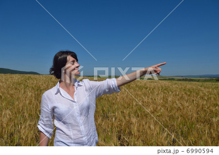 young woman in wheat field at summer 6990594