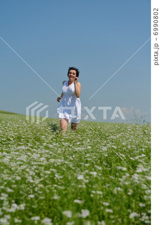 Young happy woman in green field Young happy woman in green field 6990802
