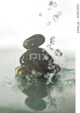 isolated wet zen stones with splashing water drops isolated wet zen stones with splashing water drops 6991093