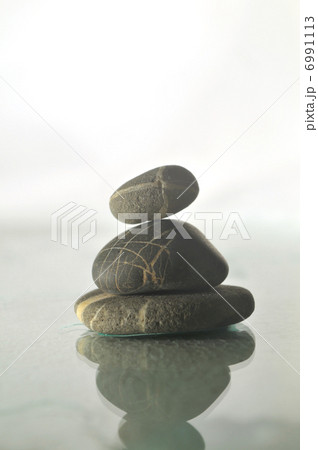 isolated wet zen stones with splashing water drops isolated wet zen stones with splashing water drops 6991113