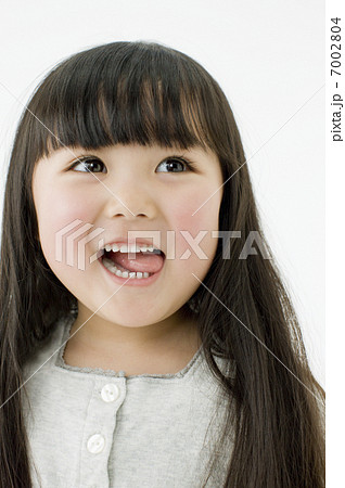 舌をだす日本人の女の子の写真素材