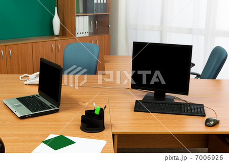 computer and laptop on a desk 7006926