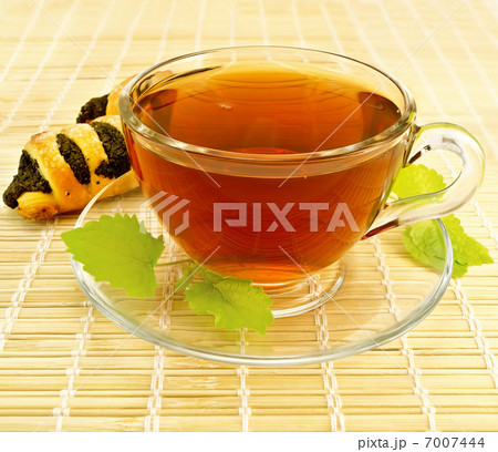 Tea with mint and cookies on a bamboo napkin 7007444