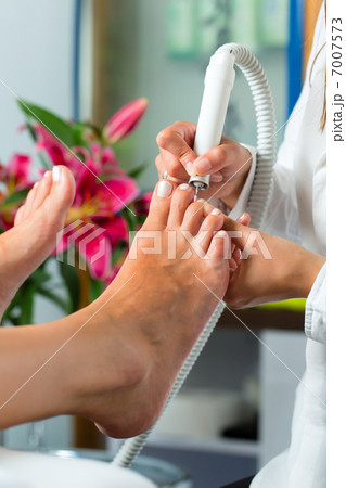 Woman in nail studio receiving pedicure 7007573