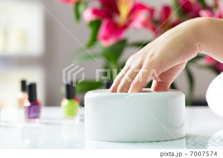 Woman in nail salon receiving manicure 7007574