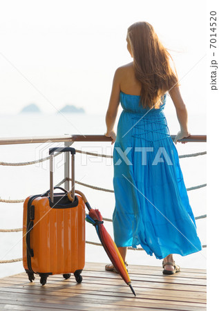 Young woman with suitcase on the pier Young woman with suitcase on the pier 7014520