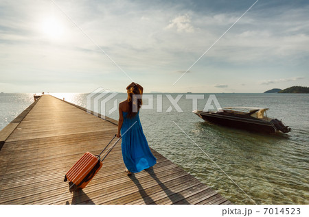 Young woman with suitcase on the pier Young woman with suitcase on the pier 7014523