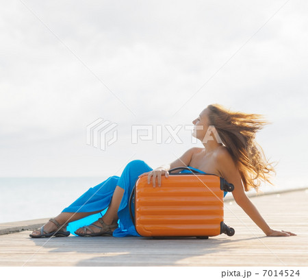 Young woman sitting on wooden pier Young woman sitting on wooden pier 7014524