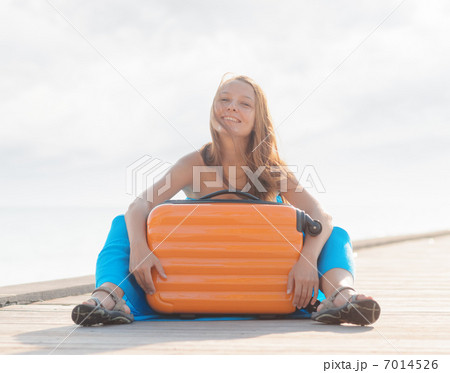 Young woman sitting on wooden pier Young woman sitting on wooden pier 7014526