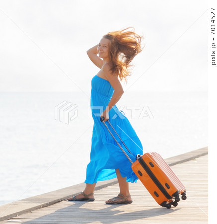 Young woman with suitcase on the pier Young woman with suitcase on the pier 7014527