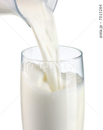 pouring milk in a glass isolated pouring milk in a glass isolated 7015264