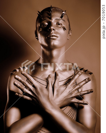 Coloring. Bodyart. Bronze Painted Man's Body in Shadow. Grace 7019053