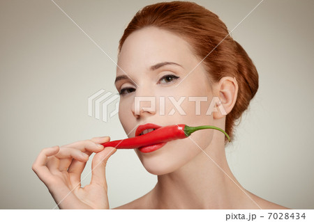 Portrait Of Beautiful Woman Biting Spicy Hot Red Cayenne Chili P 7028434