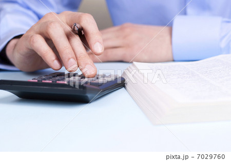 hand and a calculator hand and a calculator 7029760