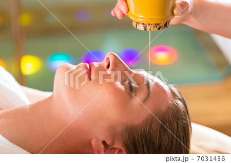 Woman enjoying a Ayurveda oil massage Woman enjoying a Ayurveda oil massage 7031436