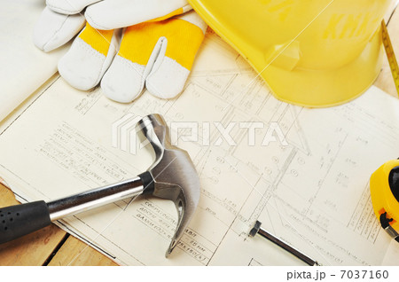 Yellow hardhat on drawings Yellow hardhat on drawings 7037160