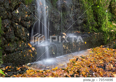small waterfall in autumn park small waterfall in autumn park 7054896