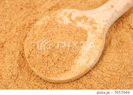 Cinnamon powder and wooden spoon as nature food background Cinnamon powder and wooden spoon as nature food background 7057049