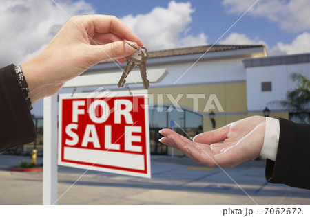 Agent Handing Over the Keys in Front of Business Office Agent Handing Over the Keys in Front of Business Office 7062672