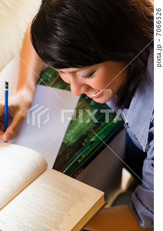 Girl with pile of books learning 7066526